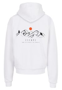 White hoodie with a drawstring hood, featuring a mountain graphic, a sun in orange, and the text "ESCAPE AND DISCOVER THE WORLD" in black.