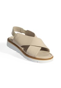 Beige leren sandaal met een kruislings ontwerp, open tenen en een elastische hielband. Voorzien van een lichte rubberen zool met een contrasterende tan rand.