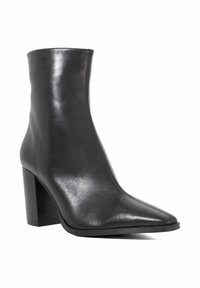 Black leather ankle boot with a pointed toe, a sleek silhouette, textured finish, and a chunky high heel.