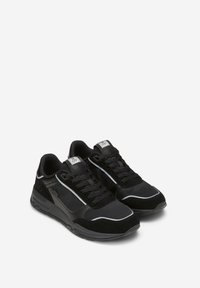 Scarpe atletiche nere realizzate con materiali in rete e suede, design con lacci, accenti riflettenti, colletto imbottito e logo sulla linguetta.
