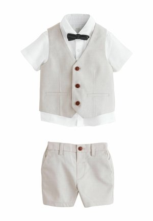 Weißes kurzärmeliges Hemd mit schwarzer Fliege, beige Weste mit Knöpfen und passende beige Shorts für ein Kleinkind.