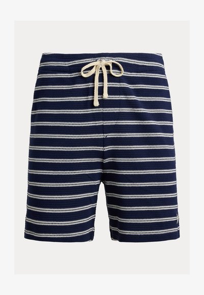 Mørkeblå strikkeshorts med horisontale hvite striper og hvit snor i livet.