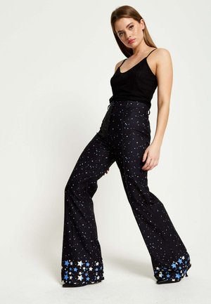 STAR PRINT - Trousers - black