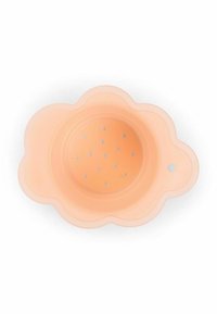 Peach-colored silicone strainer with a scalloped flower shape and small drainage holes in the center, featuring a hole for hanging.