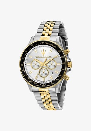 Orologio cronografo con quadrante argento, dettagli dorati, cassa in acciaio inossidabile e bracciale metallico bicolore. Presenta tachimetro e più quadranti.