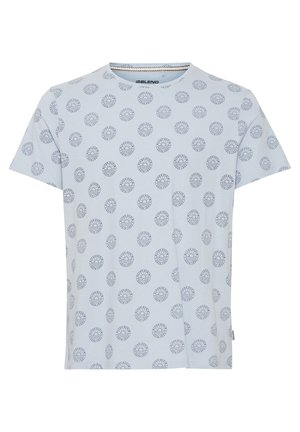 Light blue short-sleeve t-shirt with circular navy printed pattern. Fabric appears soft; round neckline with no visible seams or embellishments.