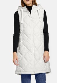 Dwuwarstwowa kamizelka bez rękawów w jasnoszarym kolorze z kapturem. Posiada zamek błyskawiczny z przodu, boczne kieszenie oraz regulowane sznurki. Gładki, lekki materiał.