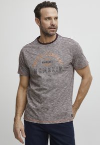 Gray textured T-shirt with a round neckline and short sleeves. Features orange and black graphics: "FQ1924 COMPANY 1974 ORIGINAL GOODS MCMXXIV."