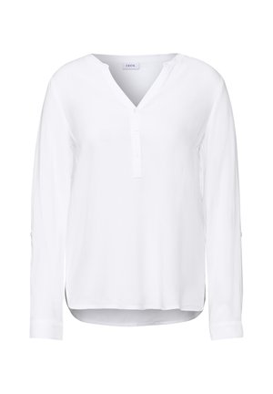 Chemise blanche à manches longues avec un col en V, patte de boutonnage et texture douce. Présente un ourlet arrondi et des manches à poignets avec des détails de bouton.