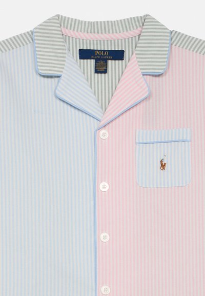 Bluzka od piżamy z wielokolorowym pionowym wzorem w paski w kolorze niebieskim, różowym i zielonym. Posiada kieszonkę z małym haftowanym logo oraz białe guziki.