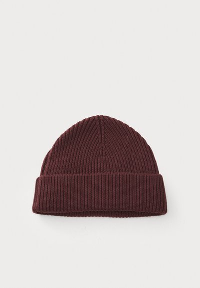 Burgundy knit beanie with ribbed texture and a folded cuff. Soft material, lightweight design, and rounded top. Suitable for cool weather.