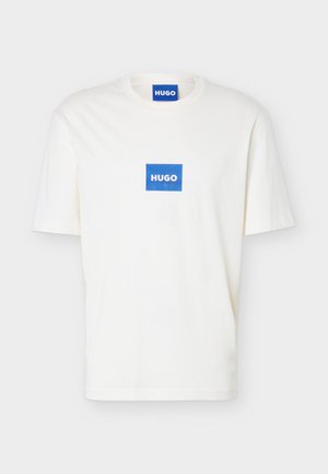 White short-sleeve crewneck T-shirt with a blue rectangular logo reading "HUGO" centered on chest and on the inner collar.
