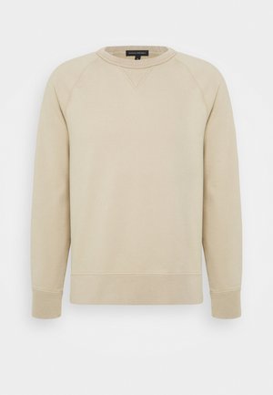 Beiger Sweatshirt mit langen Ärmeln und Rundhalsausschnitt, mit gerippten Bündchen und Saum, mit einem kleinen aufgenähten Dreieck unter dem Kragen.