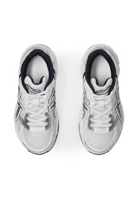 White mesh athletic shoes with silver accents, black detailing on the tongue and inner lining, featuring laces and a textured sole.