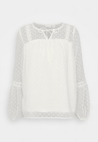 Blouse blanche à pois, en tissu transparent, avec encolure ronde, détail en lien, manches ballon élastiques et accents en dentelle sur les épaules.