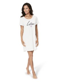 White short-sleeve nightgown featuring a round neck, relaxed fit, and black text "self Love" with a pink heart graphic. Soft fabric.