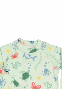 Light green rash guard with aquatic-themed prints, including turtles, crabs, and starfish. Features a round neck and raglan sleeves.