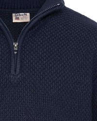 Granatowy sweter dzianinowy z teksturowanym wzorem, z zamkiem błyskawicznym na pół i wysokim kołnierzem. Metka widoczna przy szyi.