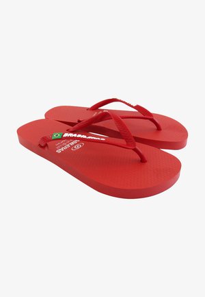 Red flip-flops made of rubber with textured footbed, thin straps, and logo detailing. Flat sole with rounded edges and Brazilian flag emblem.