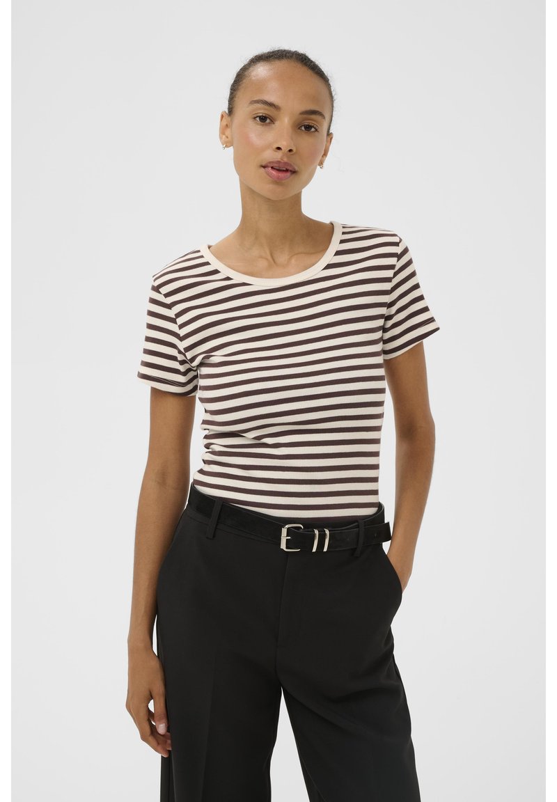 Brown and cream striped t-shirt with a round neckline, short sleeves, and ribbed texture, paired with high-waisted black trousers.