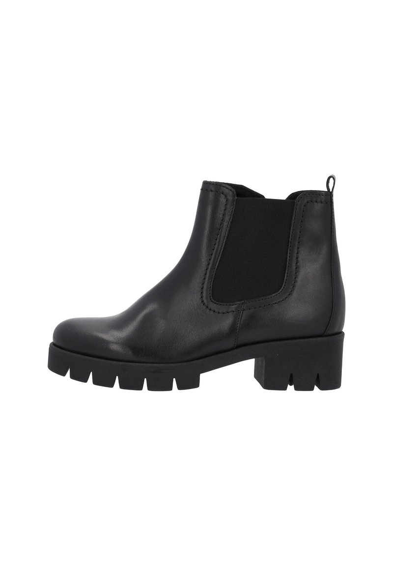 Bottines en cuir noir avec des panneaux élastiques sur les côtés, bout rond et semelle épaisse à bande de roulement. Dispose d'une languette à l'arrière pour un enfilage facile.