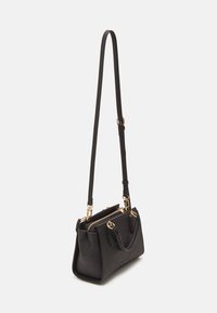 Black leather handbag with a structured shape, gold hardware accents, and a detachable shoulder strap. Features zippered closure and top handles.