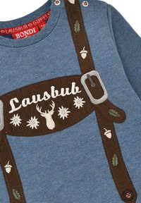 Blaues Sweatshirt mit braunen gestickten Hosenträgern, verziert mit einem Reh, Blumen, Eicheln und Blättern. Enthält dekorative Knöpfe und eine weiche Textur.