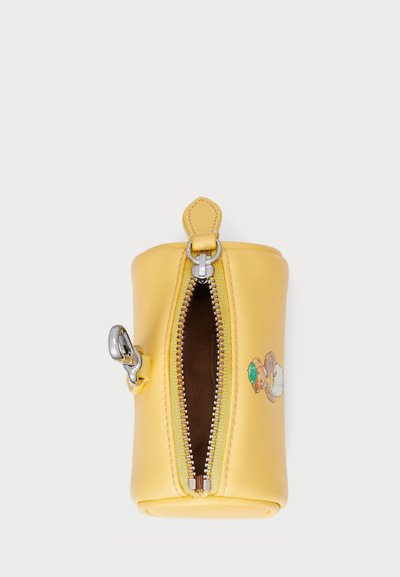 Yellow leather zip pouch with a smooth texture, silver zipper, and a decorative patch. Interior lined with brown fabric.