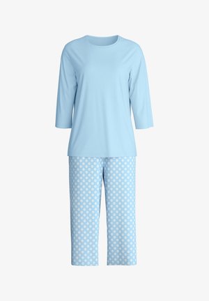 Lichtblauw top met lange mouwen gecombineerd met lichtblauwe cropped broek met een patroon van gelijkmatig verdeelde witte stippen.