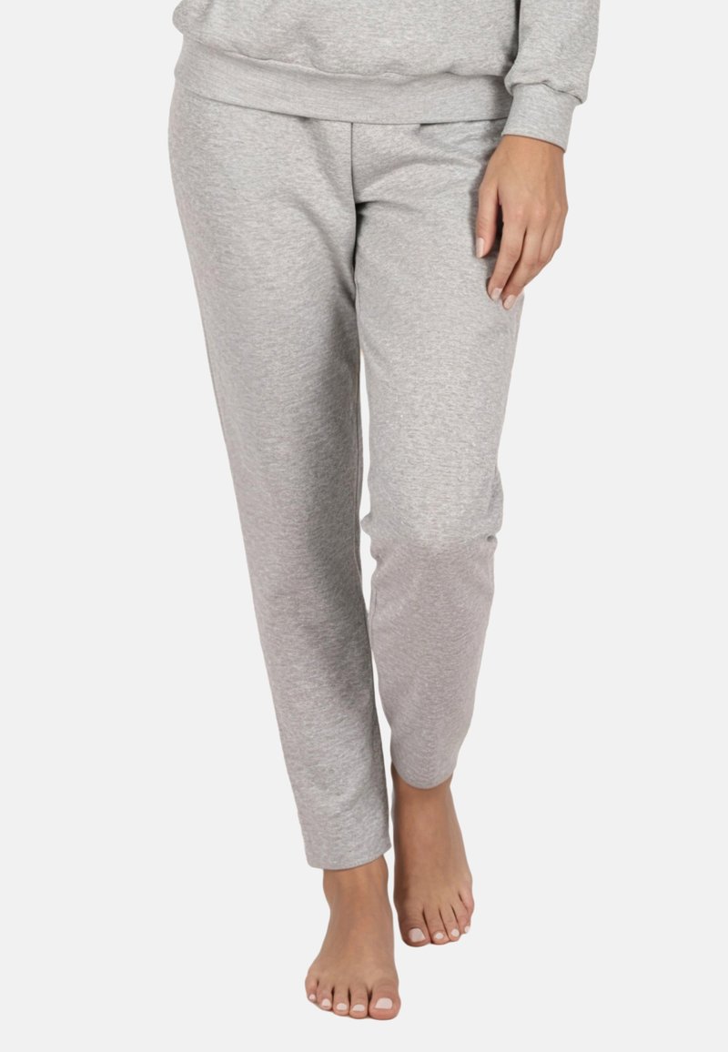 Szürke melegítőnadrág puha, rugalmas anyagból, karcsúsított szabással, gumis derékpánttal és oldalzsebekkel, minták nélkül.