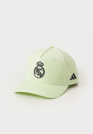 Light green adjustable baseball cap featuring a black and white Real Madrid logo on the front and black Adidas stripes on the side.