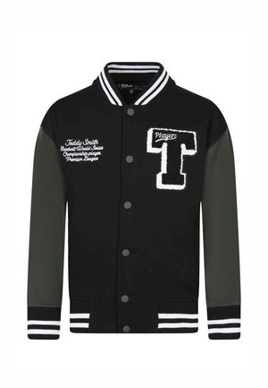 Veste universitaire noire et gris foncé avec col et poignets rayés, large écusson en forme de "T" sur la poitrine, et texte blanc brodé sur le côté gauche.