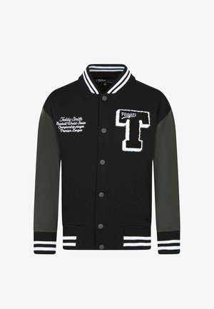 Veste universitaire noire et gris foncé avec col et poignets rayés, large écusson en forme de "T" sur la poitrine, et texte blanc brodé sur le côté gauche.