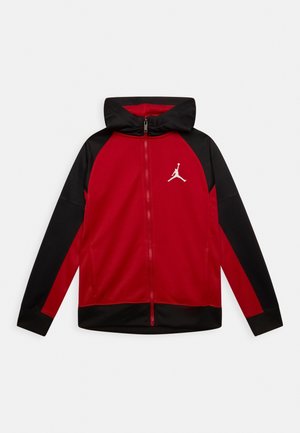Veste à capuche zippée rouge et noire avec manches longues et logo Jumpman blanc sur la poitrine gauche.