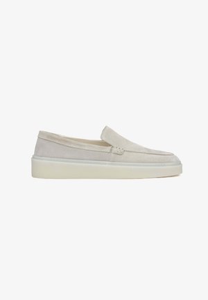 Light gray slip-on shoes made from suede, featuring a rounded toe and a white rubber sole with minimal stitching details.