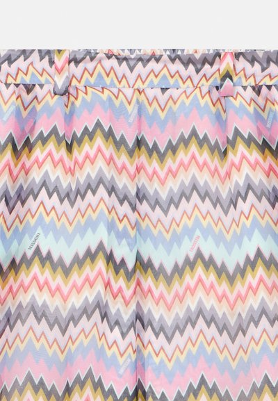 Chevron zigszag vzor v pastelových farbách na skladanej tkanine s pútkami na opasok, so subtilnými textovými logami "Missoni" po celom povrchu.