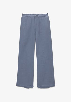 Pantalons larges en tissu bleu doux avec une finition texturée. Dotés d'une taille élastique avec cordon de serrage et d'ourlets bruts.