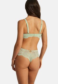 Ensemble de lingerie en dentelle vert menthe comprenant un soutien-gorge légèrement rembourré avec des bretelles réglables et des culottes taille haute assorties avec des détails en dentelle.