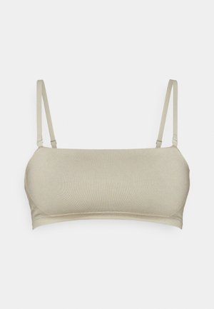 Beige ülemine rinnahoidja reguleeritavate rihmadega, sujuva tekstuuriga, ilma kaarte ja kergelt kujundatud tassi. Minimalistlik disain puhaste joontega.