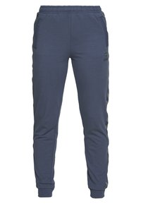 Marinblåa sweatpants med elastisk midja, tapered ben, sidfickor och sidostråk i camouflage-mönster. Mjuk, elastisk material.