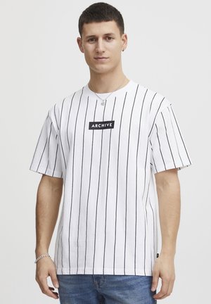 Short-sleeve white t-shirt with vertical black stripes, featuring a black rectangular "ARCHIVE" logo at the center.