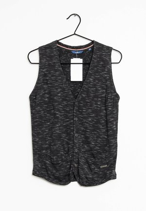 Veste sans manches gris foncé à boutons avec un motif subtil de taches blanches, suspendue à un cintre en métal noir.
