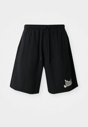 Calções atléticos pretos com uma cintura elástica e cordão, apresentando um proeminente logótipo "JORDAN" e um pequeno ícone vermelho.