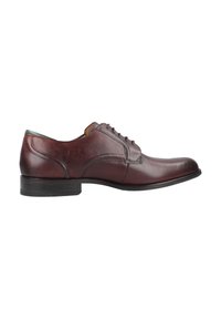 Dunkelbraune Lederschuhe mit runder Zehenform, Schnürdetails, grünem Akzent an der Ferse und einem niedrigen schwarzen Gummihacken.