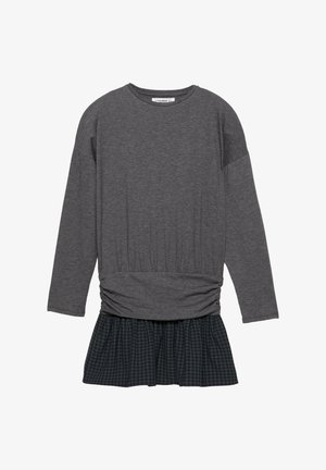 Grå langærmet top med talje, der er samlet, kombineret med et sort og grønt ternet skørt. Blødt stof med afslappet pasform.