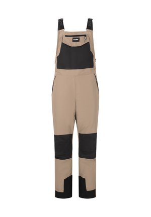 Beige vandtætte overalls med sorte detaljer, justerbare stropper, lomme med lynlås foran, sidelommer med lynlås og forstærkede knælapper for holdbarhed.