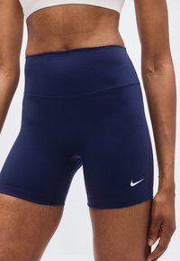 Μπλε ναυτικό αθλητικό σορτς από ελαστικό ύφασμα. Διαθέτει ψηλή μέση και μικρό λευκό λογότυπο Nike στο κάτω αριστερό πόδι.