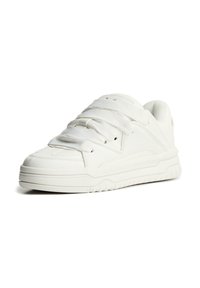 White sneaker made of smooth synthetic material, featuring a rounded toe, thick sole, and prominent laces. Textured accents on the upper.