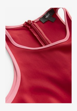 Rotes Sportoberteil aus strapazierfähigem Stoff mit pinken Akzenten und einem Reißverschluss auf der Rückseite. Das Design umfasst einen runden Ausschnitt und eine glatte Oberfläche.