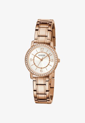 Orologio in oro rosa con quadrante rotondo, bezel decorato con cristalli, indicatori delle ore argentati e bracciale a maglie in metallo. È dotato di movimento al quarzo.
